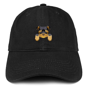 May include: A black baseball cap with an embroidered image of a small black and brown dog peeking over the brim.