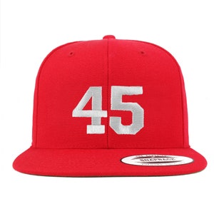 May include: Red baseball cap with a white embroidered number 45 on the front.