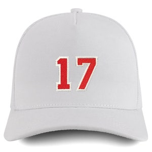 May include: White trucker hat with a red number 17 embroidered on the front.