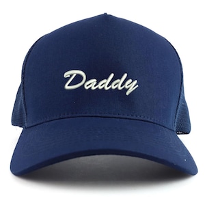 May include: Navy blue trucker hat with the word "Daddy" embroidered in white script across the front. The hat features a mesh back for breathability and a curved brim.