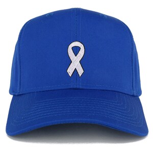 May include: A royal blue baseball cap with a white ribbon embroidered on the front.