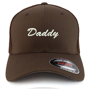 May include: A brown baseball cap with a mesh back and a curved brim. The word "Daddy" is embroidered in white script across the front. The Flexfit logo is visible on the brim.