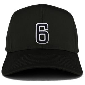 May include: Black baseball cap featuring the number 6 in white with a black outline. The cap has a curved brim and a structured crown. The number is centered on the front of the cap.