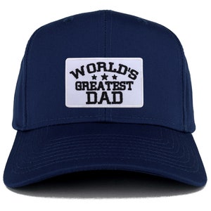 Puede incluir: Una gorra de béisbol azul marino con un parche blanco que dice "WORLD'S GREATEST DAD" en letras negras con tres estrellas.