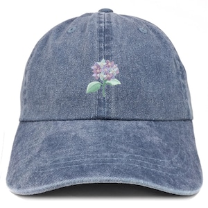 May include: A blue denim baseball cap with an embroidered purple and white flower design.
