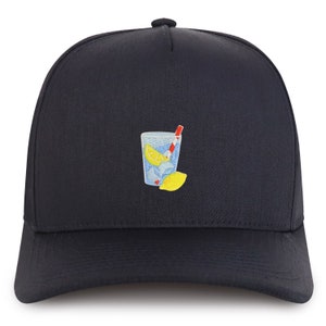 May include: A black trucker hat with an embroidered image of a glass of lemonade with a lemon wedge and a red and white straw.