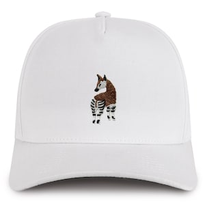 May include: White baseball cap with an embroidered image of an okapi, a mammal native to the Democratic Republic of the Congo.