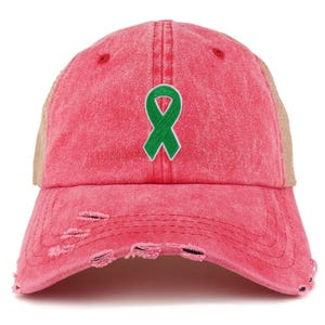 May include: A distressed pink baseball cap featuring a green ribbon emblem. The cap has a mesh back and a pre-curved peak with distressed detailing. The hat is a one-size-fits-all.