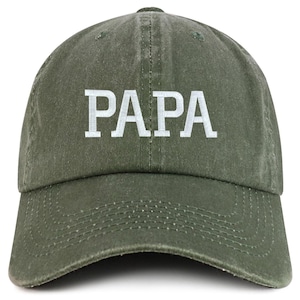 May include: Olive green baseball cap with the word "PAPA" embroidered in white block letters across the front. The cap has a curved brim and an adjustable strap at the back.