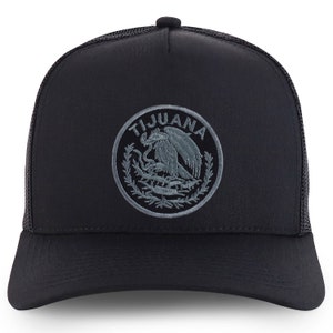 May include: Black trucker hat with a gray embroidered patch featuring the Mexican coat of arms and the word "TIJUANA".