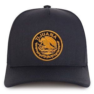 May include: A black trucker hat with a gold embroidered emblem featuring the Mexican coat of arms and the word "TIJUANA".