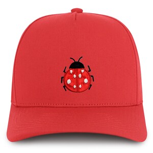 May include: Red baseball cap with a black and white ladybug embroidered on the front.