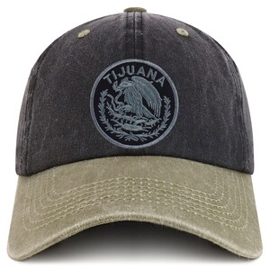 May include: A black and green baseball cap with a distressed look. The front of the cap features a circular embroidered patch with the text "TIJUANA" and a stylized image of an eagle.