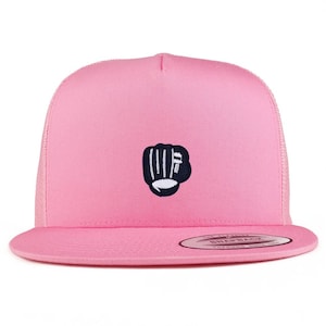 May include: A pink baseball cap with a flat peak and mesh back. The cap has a navy blue and white embroidered fist design on the front. It features a snapback closure for an adjustable fit.
