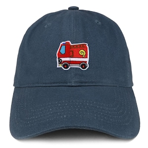 May include: A navy blue baseball cap featuring a colorful embroidered fire truck design. The fire truck is red with white and yellow accents, and has a blue window. The cap has a curved brim and an adjustable strap.