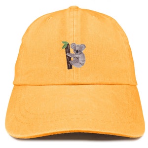 May include: A yellow baseball cap with an embroidered koala bear on a tree branch. The koala is gray and has a brown nose.