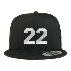 May include: A black trucker hat with a white mesh back. The hat has a white embroidered number "22" on the front.