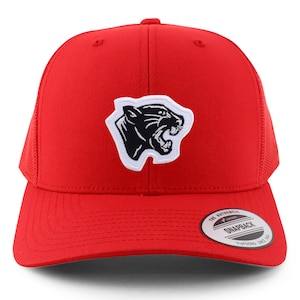 May include: Red trucker hat with a black panther logo patch. The hat features a mesh back and a curved brim. The patch is a black panther head with white outlining. The hat has a snapback closure.