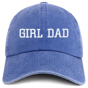May include: A blue baseball cap with the white text "GIRL DAD" embroidered on the front. The cap has a curved brim and an adjustable strap at the back. The hat is made of a soft, worn material.