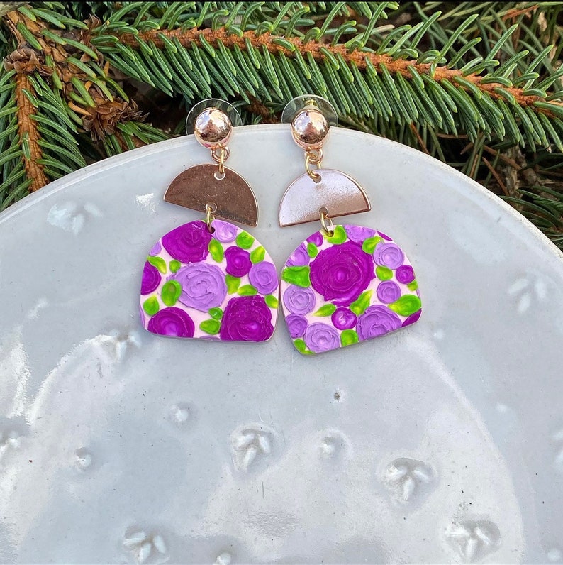 Gold and clay earrings with purple flowers image 1