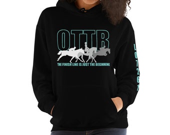 May include: Black hooded sweatshirt with a white graphic of horses and riders. The text "OTTB THE FINISH LINE IS JUST THE BEGINNING" is printed on the front. The number "107267" is printed on the left sleeve.