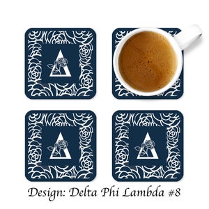 May include: Set of four blue and white coasters with a white rose and triangle design. The coasters feature a white floral pattern and the text "Design: Delta Phi Lambda #8".