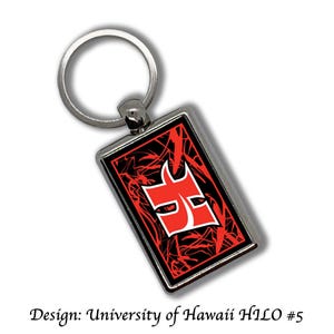 May include: A silver keychain with a red and black rectangular tag. The tag features a red and white logo with the text "University of Hawaii Hilo #5".