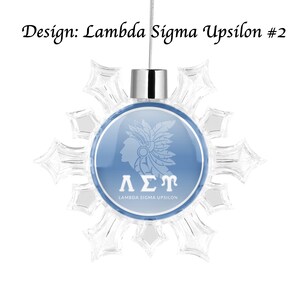 May include: A blue and white snowflake ornament with a white image of a Native American headdress and the letters "&Lambda;&Sigma;&Gamma;" with the text "Lambda Sigma Upsilon" below.