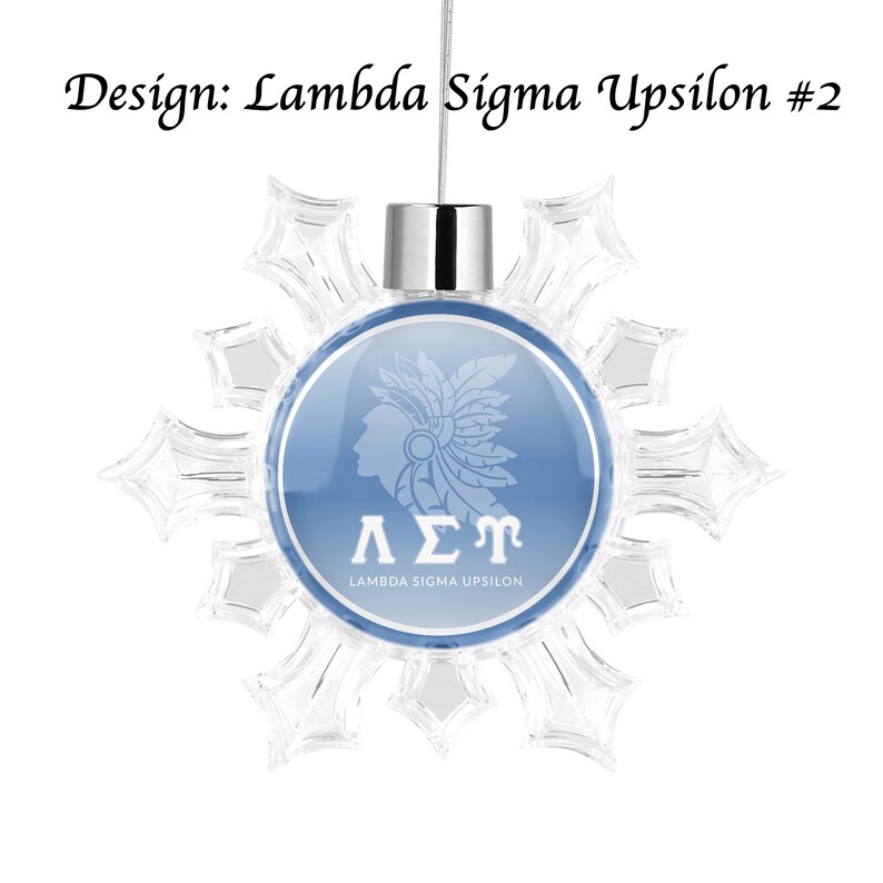 May include: A blue and white snowflake ornament with a white image of a Native American headdress and the letters "&Lambda;&Sigma;&Gamma;" with the text "Lambda Sigma Upsilon" below.