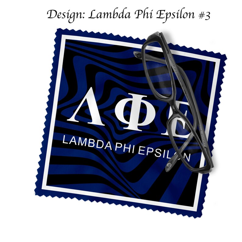 May include: Black-framed spectacles lie on a cleaning cloth with a blue and black wavy pattern. The cloth displays the Greek letters Lambda, Phi, and Epsilon, with the text "LAMBDA PHI EPSILON". The design is labelled "Design: Lambda Phi Epsilon #3".