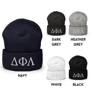 May include: A set of six beanies in various colours, including navy, dark grey, heather grey, white, and black. Each beanie features a white embroidered Greek letter design, "&Delta;&Phi;&Lambda;".