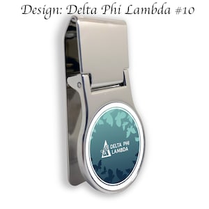 May include: Silver money clip with a round, blue and green design featuring a white butterfly and the text "Delta Phi Lambda".