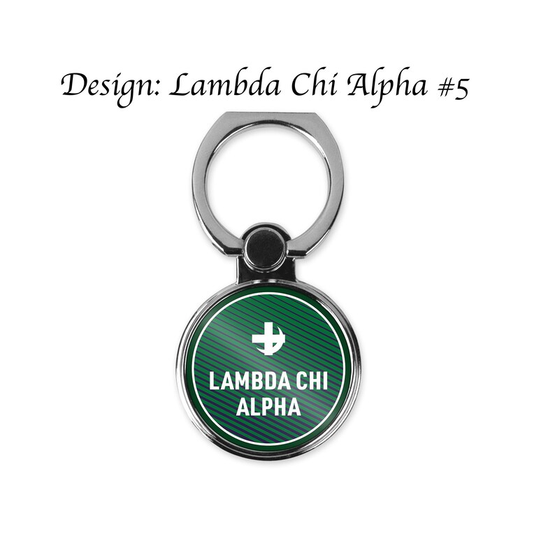 May include: A silver phone ring holder with a green and blue circle. The circle has a white cross and the text "Lambda Chi Alpha".
