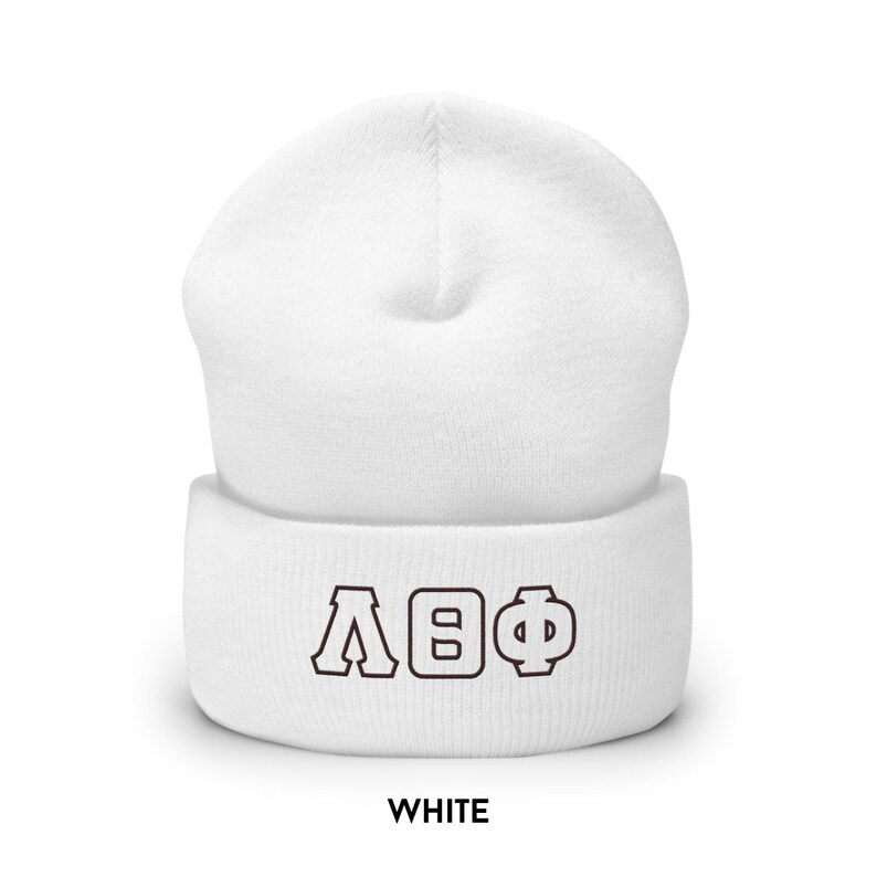May include: White beanie hat featuring the Greek letters &Lambda;&Theta;&Phi; in brown. The word "WHITE" is printed in a bold, sans-serif font at the bottom of the hat.