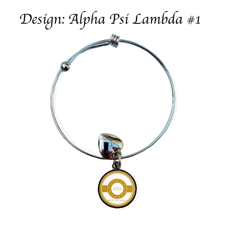 May include: A silver expandable bracelet with a charm featuring a gold circle with the letters "AWA" in white and the text "Alpha Psi Lambda" in smaller white letters.
