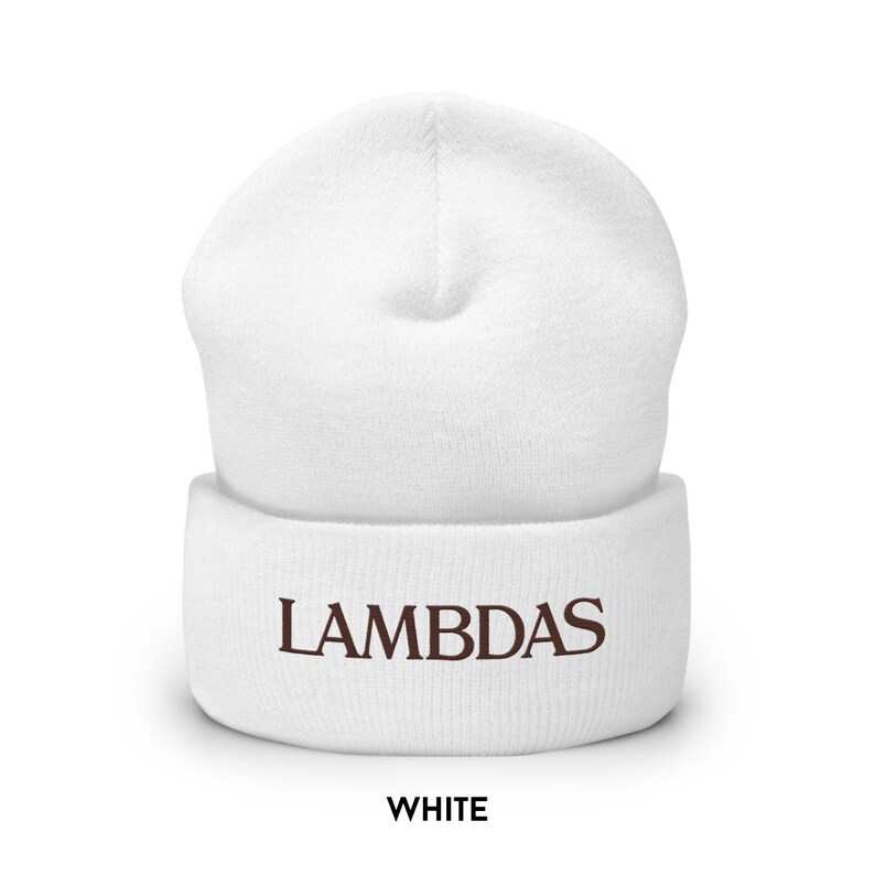 May include: A white beanie hat with the word "LAMBDAS" embroidered in brown. The word "WHITE" is printed below the hat in a bold font. The hat is made of a soft, knitted material.
