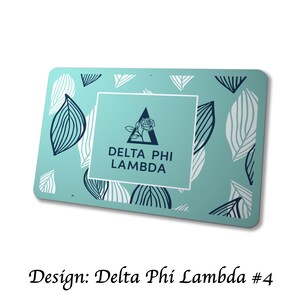 May include: A rectangular teal card with a white border, featuring a central square with the text "DELTA PHI LAMBDA" and a rose graphic. The card is decorated with white and navy leaf patterns. The text "Design: Delta Phi Lambda #4" is at the bottom.