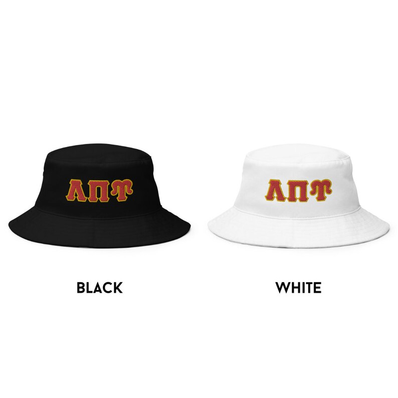 May include: Two bucket hats with the letters "A&Pi;&Gamma;" in red with a gold outline. The hat on the left is black and the hat on the right is white.