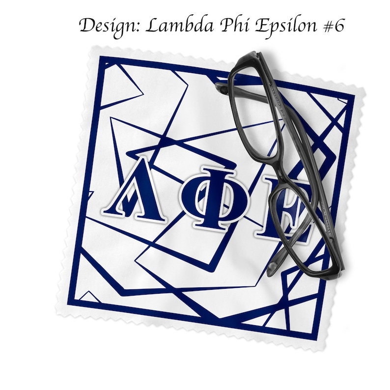 May include: A white cleaning cloth featuring a blue geometric pattern and the Greek letters &Lambda;&Phi;E. Black spectacles are placed on the cloth. The text "Design: Lambda Phi Epsilon #6" is visible.