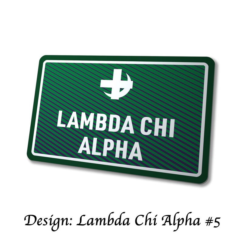 May include: A green and white sign with the text "LAMBDA CHI ALPHA" in white capital letters. The sign has a white border and a white cross symbol at the top. The words "Design: Lambda Chi Alpha #5" are at the bottom.