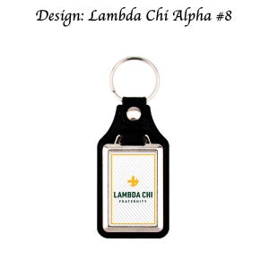 May include: Black leather keychain with a silver-colored rectangular frame. The keychain features the text "Lambda Chi Fraternity" and a gold and green logo on a white background. The design is labeled "Lambda Chi Alpha #8".