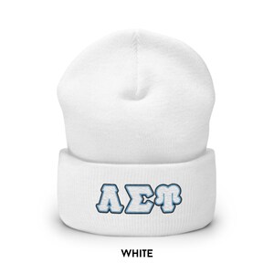 May include: White beanie with a blue and white embroidered "A&Sigma;&Phi;" logo.