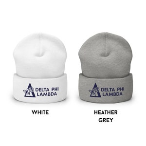 May include: Two knit beanies with a navy blue Delta Phi Lambda logo featuring a rose and triangle. The beanie on the left is white and the beanie on the right is heather grey.