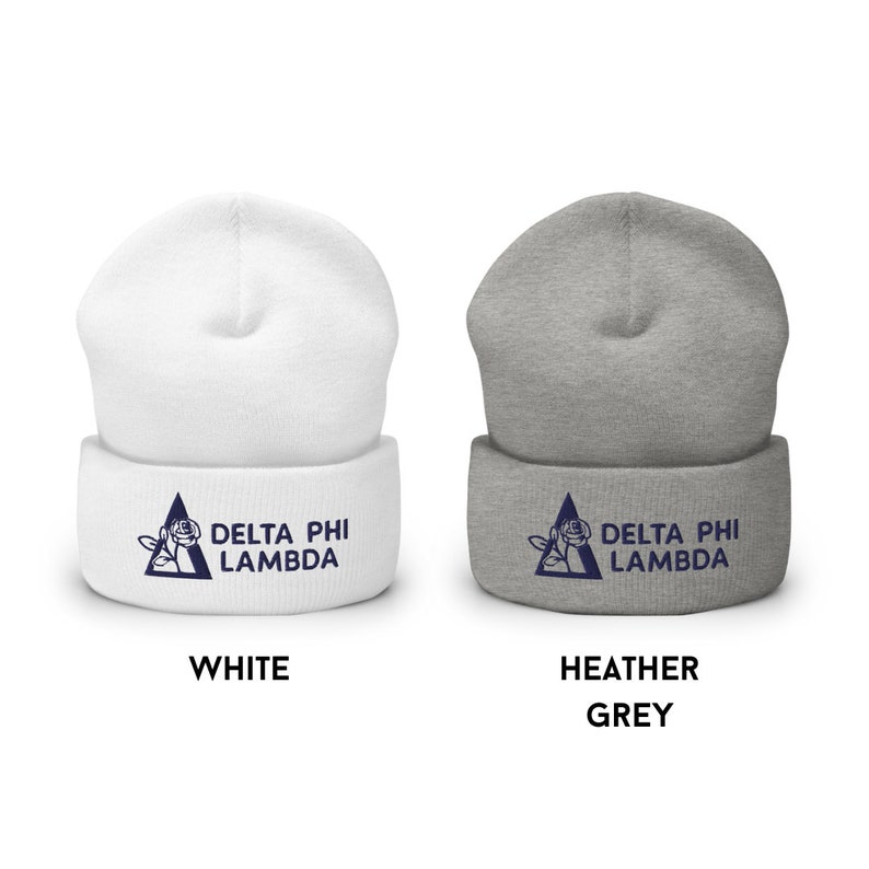 May include: Two knit beanies with a navy blue Delta Phi Lambda logo featuring a rose and triangle. The beanie on the left is white and the beanie on the right is heather grey.