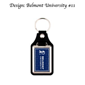 May include: Black leather keychain with a silver rectangular frame. The frame contains a blue background with a white logo that says "Belmont University".