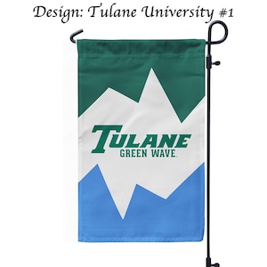 May include: A rectangular garden flag featuring a green, white, and blue zigzag pattern. The text "Tulane GREEN WAVE" is printed in green across the center. The flag hangs from a black metal stand. The text "Design: Tulane University #1" appears above.