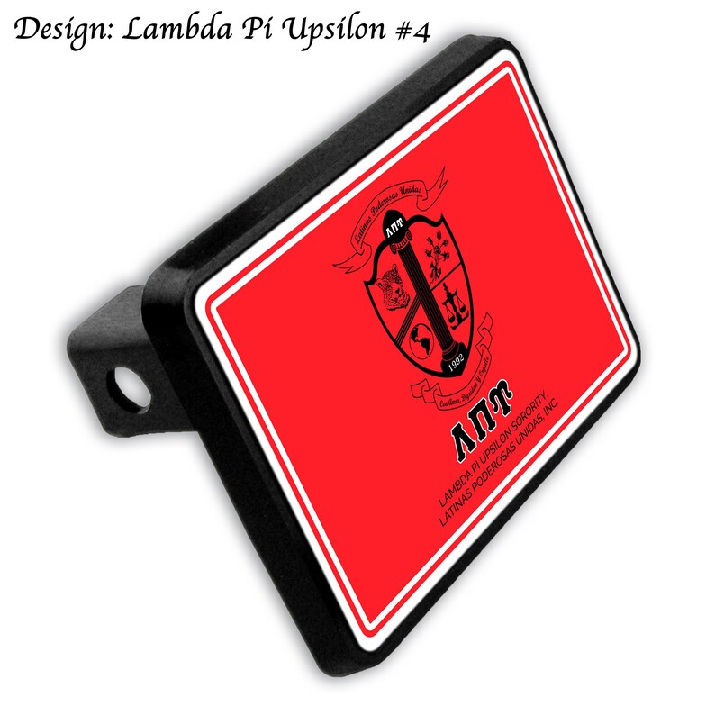 May include: Black rectangular hitch cover with a red background and white border. The cover features the Lambda Pi Upsilon sorority crest and text. The design includes the sorority's name and founding year, 1992.