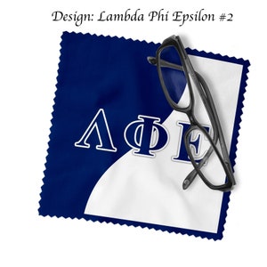 May include: A blue and white microfiber cleaning cloth featuring the Greek letters Lambda, Phi, and Epsilon in white. Black eyeglasses are placed on the cloth. The text "Design: Lambda Phi Epsilon #2" is at the top.
