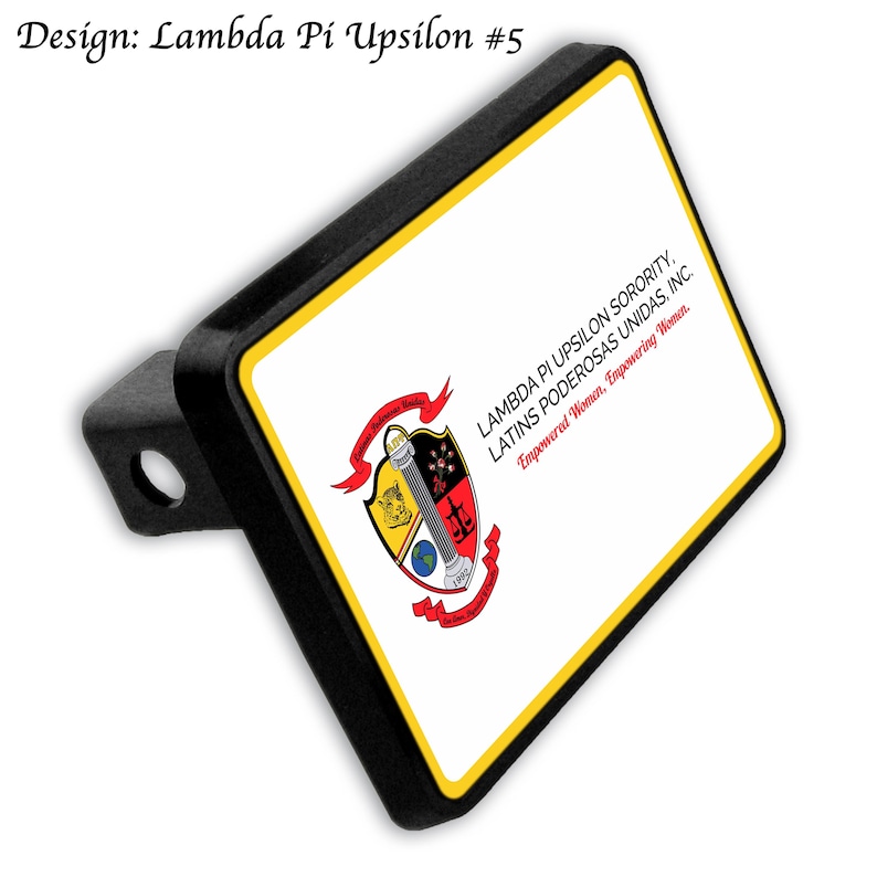 May include: A black and yellow hitch cover featuring the Lambda Pi Upsilon Sorority emblem. The emblem includes a shield with a globe, scales, and a column. The text "LAMBDA PI UPSILON SORORITY, LATINS PODEROSAS UNIDAS, INC. Empowered Women, Empowering Women" is also visible.