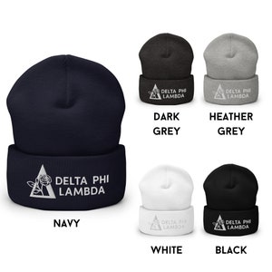 May include: A set of five knit beanies in navy, dark grey, heather grey, white and black. Each beanie features a white embroidered triangle with a rose and the text "DELTA PHI LAMBDA".